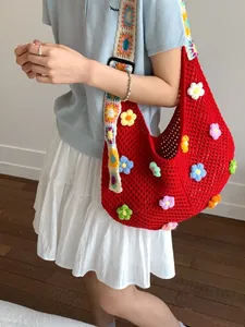 Grande borsa hobo rossa all'uncinetto con ricami floreali e tracolla geometrica larga