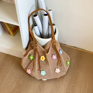 Close-up of handmade crochet tote bag featuring multi-color floral 3D embroidery detail