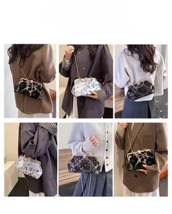 Detail of embroidered vintage crossbody bag showing various carrying styles and textures