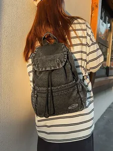 Vintage black washed denim backpack with drawstring closure and flap cover for daily commute