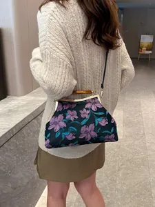 Vintage floral fabric handbag with metallic clasp and wood grain handle for women