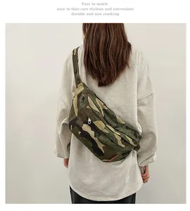 Close-up of camouflage canvas crossbody bag with zipper pocket and adjustable strap