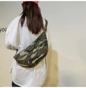 Detail view of camouflage canvas crossbody bag with adjustable silver metal strap buckle