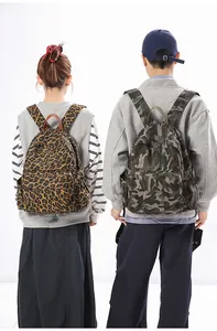 Detail showing two canvas backpacks with leopard and camouflage prints for outdoor travel