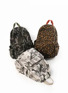 Detailed comparison of camouflage and leopard print backpacks with large main compartments