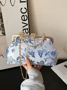 Elegant Chinese style clutch bag with blue floral patterns and golden metal handle
