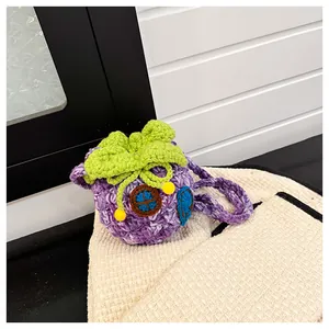 Detail of handmade purple crochet berry bag showing intricate knit texture and blue door