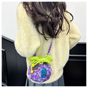 Macro detail of a handmade purple crochet mushroom bag with knitted shoulder strap