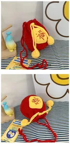 Detailed view of handmade crochet lucky bag with red yarn and yellow Fu character embroidery