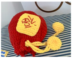 Close-up of red crochet drawstring bag with yellow Fu character patch and yarn texture