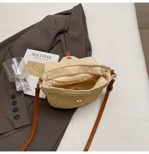 Détail de l'intérieur du sac en paille avec compartiment principal et poche zippée