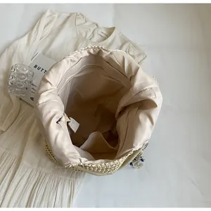 Detail view of woven tote bag interior showing beige lining and zipper pocket