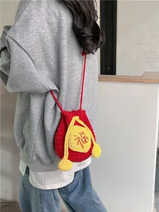 Handmade red crochet drawstring crossbody bag with yellow accents and Fu character