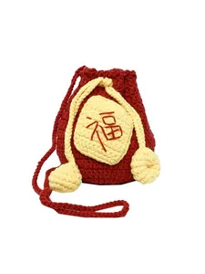 Handmade red crochet lucky bag with yellow pom-poms and embroidered Fu character