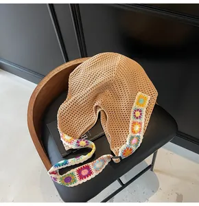 Detail of bohemian hollow-out crochet tote bag with colorful sunflower floral accents