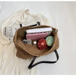 Detailed interior of a brown straw tote bag showing spacious capacity for daily essentials