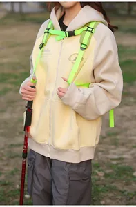 Outdoor-Hiker-Detail mit beigem Color-Block-Hoodie und neongrünen Funktionsgurten