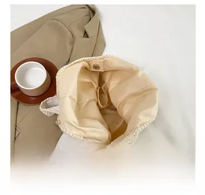 Top view of beige crochet tote showing interior fabric lining and functional inner pocket