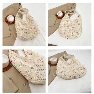 Close-up of handmade crochet straw shoulder bag with colorful beads and floral cutouts