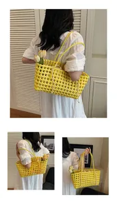 Detail of yellow woven hollow tote bag featuring a drawstring inner pouch and stylish handle