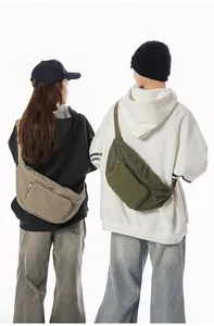 Detail view of khaki and army green canvas chest bags featuring multi-pocket design