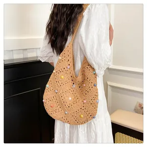 Detail of hand-woven tote bag with 3D floral textures and colorful pearl embellishments