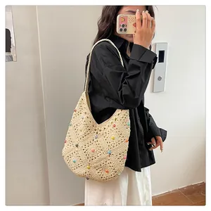 Detailed close-up of handmade hollow crochet tote bag with colorful beads for beach vacations