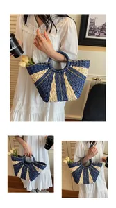 Detailed close-up of navy and beige striped woven straw beach tote bag