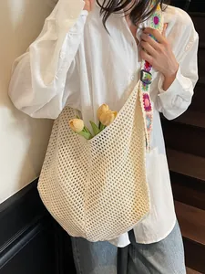 Large beige hollow woven tote bag with colorful floral embroidered shoulder strap