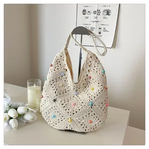 Detailed close-up of woven bag with colorful beads and floral crochet texture