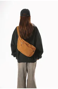 Brown canvas crossbody bag shown on a model highlighting its large capacity and fit