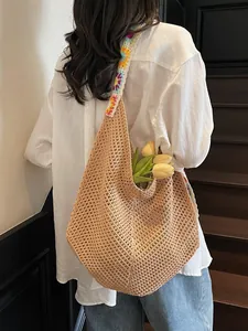 Handmade crochet hollow woven tote bag with colorful floral strap for beach travel