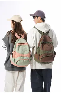 View of canvas color-blocking backpacks on models showing size and fit for travel