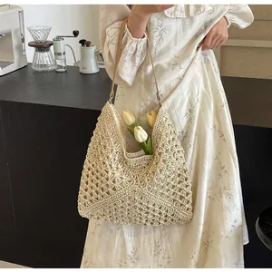 Close-up of hollow woven straw bag with beige texture and leather shoulder strap