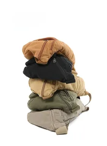 Close-up of durable canvas chest bags in five colors with textured fabric and zipper detail