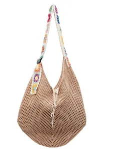 Hollow crochet tote bag with colorful floral shoulder straps and drawstring closure