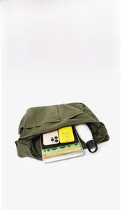 Detailed internal view showing large capacity storage in green canvas messenger bag