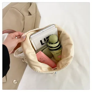Interior view of beige straw tote bag showing spacious capacity for tablets and umbrellas