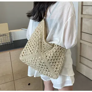 Detailed close-up of a hollow knit straw beach bag showing the woven texture and large capacity