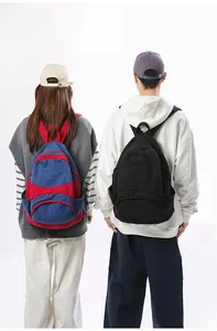 Detailed comparison of contrast blue-red and classic black casual canvas backpacks for travel
