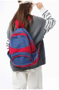 Detail of navy and red contrast backpack featuring durable canvas and reinforced stitching