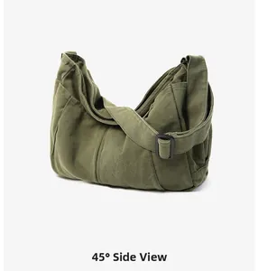 45-degree side view of vintage army green washed canvas messenger bag with adjustable strap