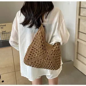 Detailed view of deep brown hollow crochet weave pattern on a casual beach tote bag
