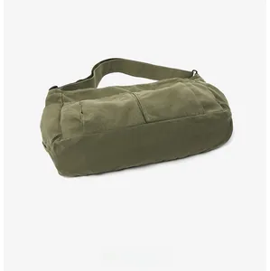 Detailed bottom view of olive green vintage canvas messenger bag with durable stitching