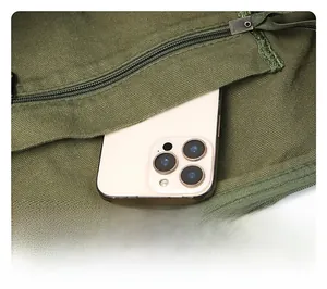 Close-up of green canvas messenger bag showing internal zipper pocket and storage space