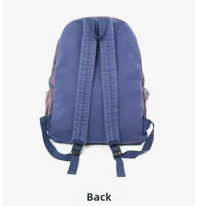 Detail view of the backpack back with padded blue shoulder straps and canvas texture