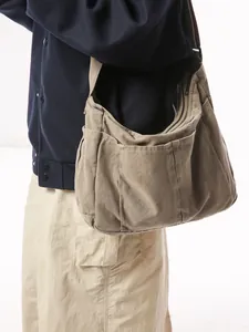 Vintage washed canvas messenger bag in khaki featuring multiple functional outer pockets
