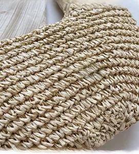 Close-up of bohemian hollow straw beach bag showing detailed crochet weave texture