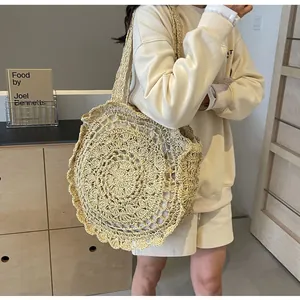 Close-up of bohemian round straw bag with woven textures and wavy lace edges