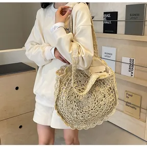 Detail of bohemian cream crochet tote bag with hollow lace pattern and fabric lining